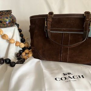 Brown Suede Coach purse with light blue trimmings.
